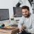 happy-photographer-holding-camera-at-his-desk-2026-01-09-11-35-37-utc-1.jpg